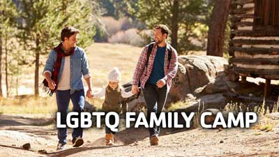 LGBTQ family camp image featuring two masculine presenting people with a toddler