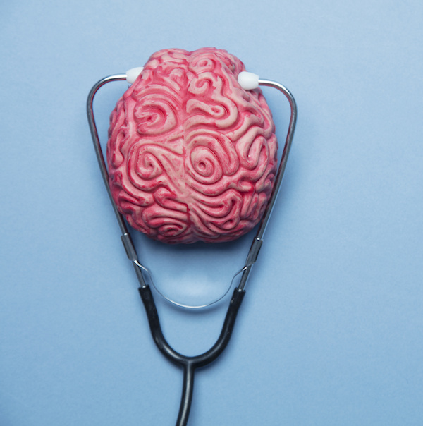 human brain surrounded by a stethoscope on a blue background
